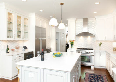 Newly remodeled kitchen. White counters, cabinets, walls, chrome appliances.