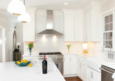Newly remodeled kitchen. White counters, cabinets, walls, chrome appliances.